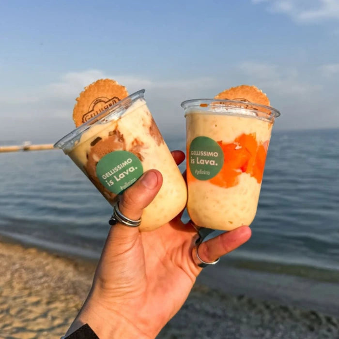 Hand holding cups of icre cream lava